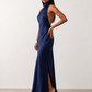 Woman wearing the Winnie satin halter maxi dress featuring a glossy satin finish, halter neckline with tie-back detail, open draped back, and a floor-length relaxed silhouette.