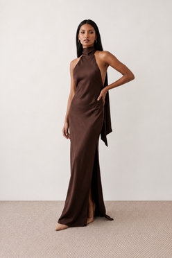 Woman wearing the Winnie satin halter maxi dress featuring a glossy satin finish, halter neckline with tie-back detail, open draped back, and a floor-length relaxed silhouette.