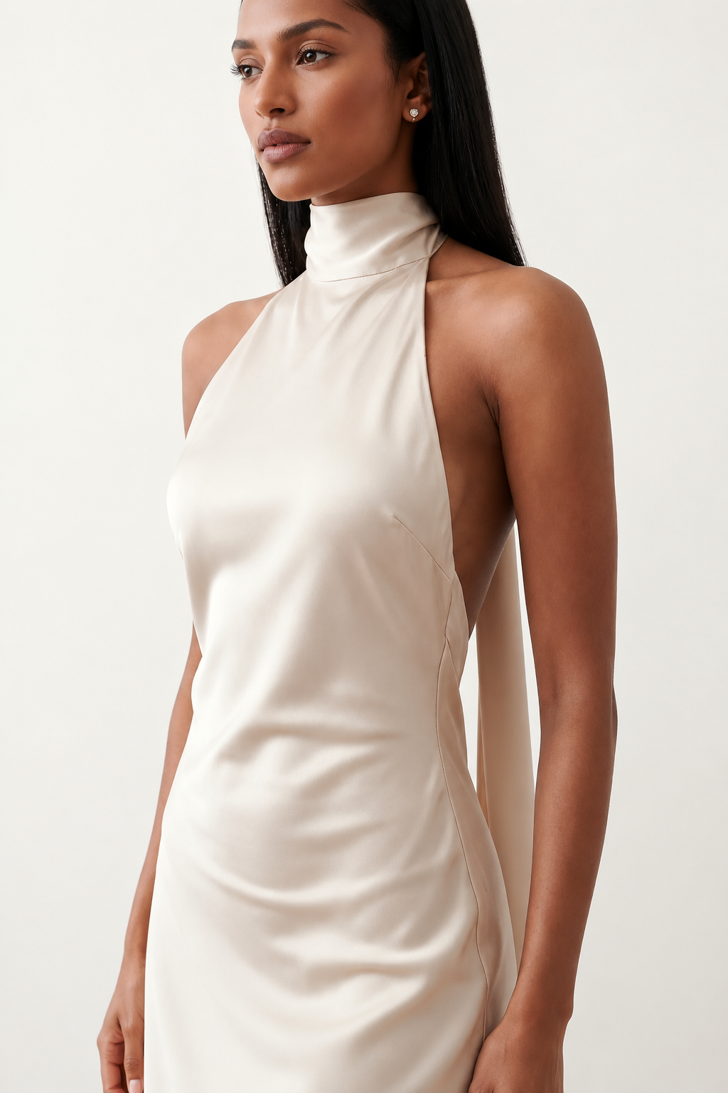 Woman wearing the Winnie satin halter maxi dress featuring a glossy satin finish, halter neckline with tie-back detail, open draped back, and a floor-length relaxed silhouette.