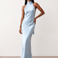 Woman wearing the Winnie satin halter maxi dress featuring a glossy satin finish, halter neckline with tie-back detail, open draped back, and a floor-length relaxed silhouette.