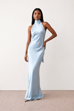 Woman wearing the Winnie satin halter maxi dress featuring a glossy satin finish, halter neckline with tie-back detail, open draped back, and a floor-length relaxed silhouette.