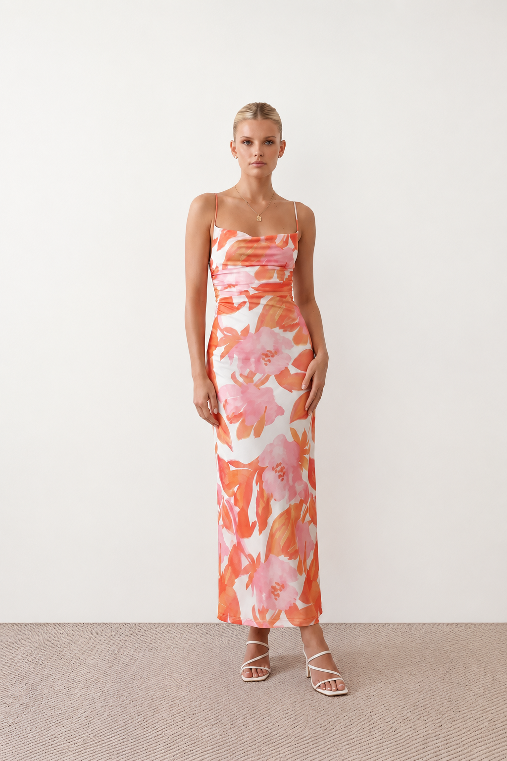 Seren spaghetti strap maxi dress in an abstract floral print featuring a square neckline, thin straps, a low lace-up open back, a shirred waist, and a fitted floor-length silhouette.