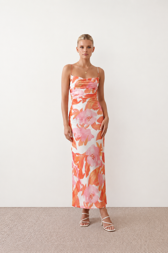 Seren spaghetti strap maxi dress in an abstract floral print featuring a square neckline, thin straps, a low lace-up open back, a shirred waist, and a fitted floor-length silhouette.