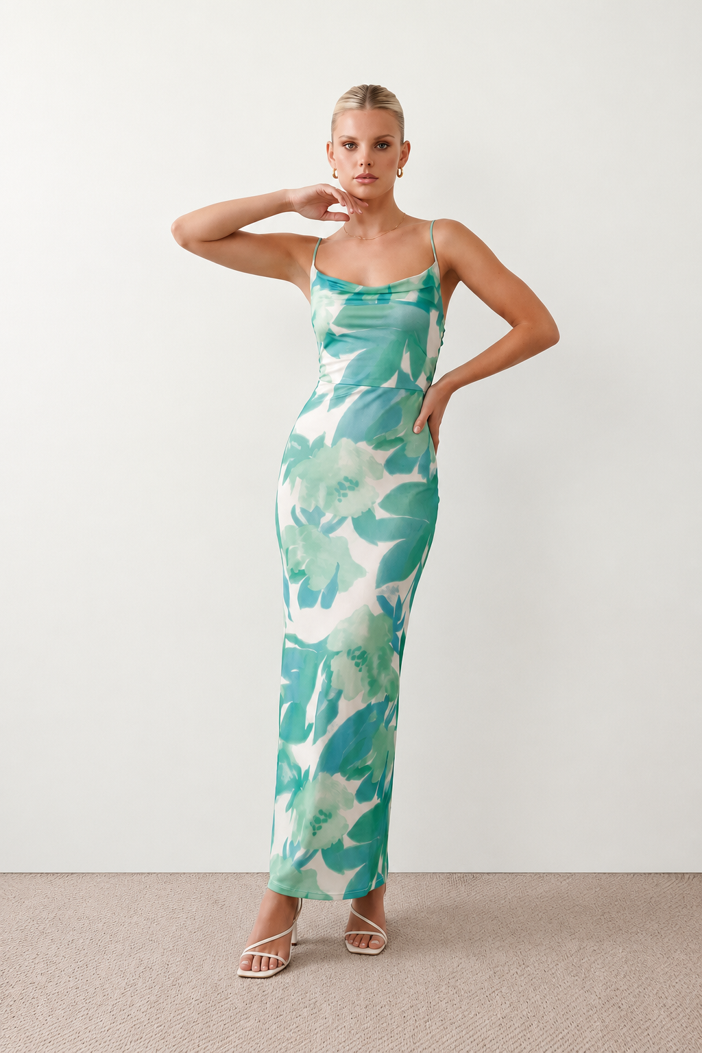Seren spaghetti strap maxi dress in an abstract floral print featuring a square neckline, thin straps, a low lace-up open back, a shirred waist, and a fitted floor-length silhouette.