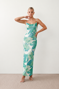Seren spaghetti strap maxi dress in an abstract floral print featuring a square neckline, thin straps, a low lace-up open back, a shirred waist, and a fitted floor-length silhouette.