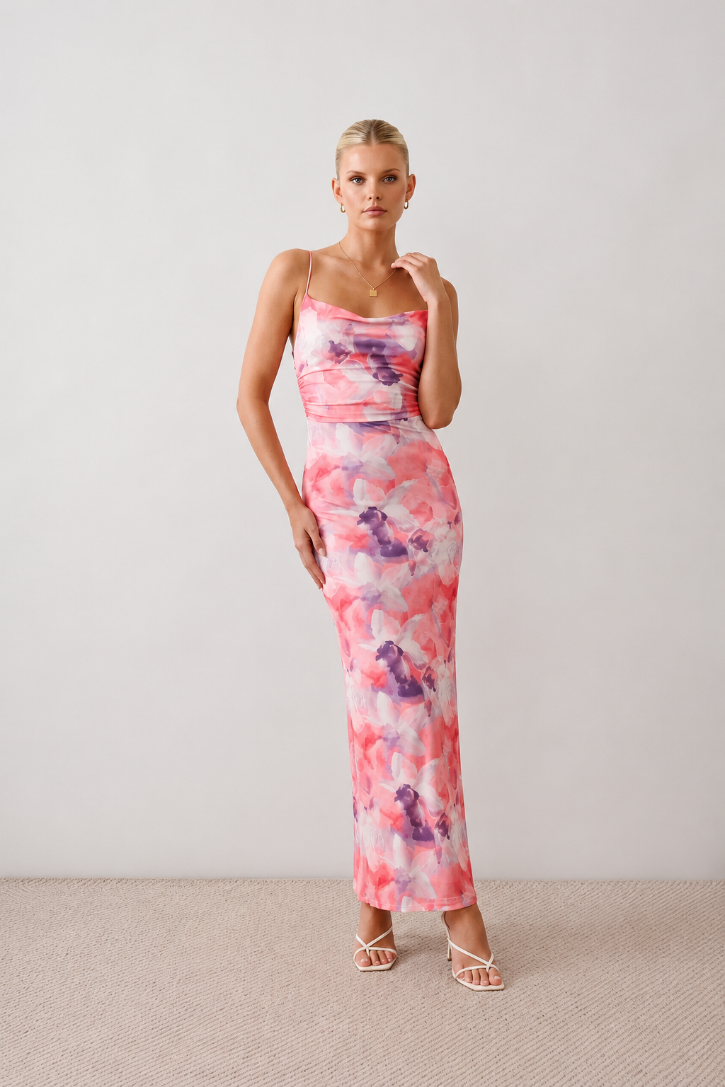 Seren spaghetti strap maxi dress in an abstract floral print featuring a square neckline, thin straps, a low lace-up open back, a shirred waist, and a fitted floor-length silhouette.