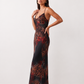 Woman wearing the Adelia Slip Spaghetti Strap Maxi Dress featuring a softly draped cowl neckline, delicate spaghetti straps, an open tie-back design and a flowing straight maxi skirt, styled for elegant evening occasions.