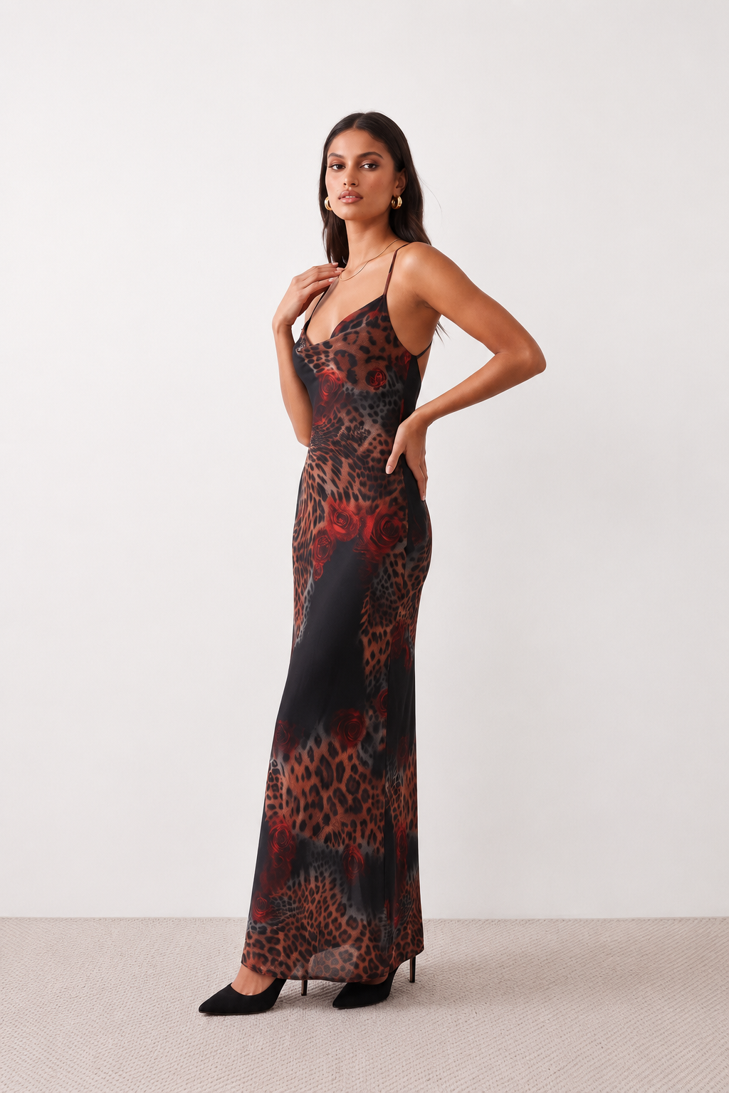 Woman wearing the Adelia Slip Spaghetti Strap Maxi Dress featuring a softly draped cowl neckline, delicate spaghetti straps, an open tie-back design and a flowing straight maxi skirt, styled for elegant evening occasions.