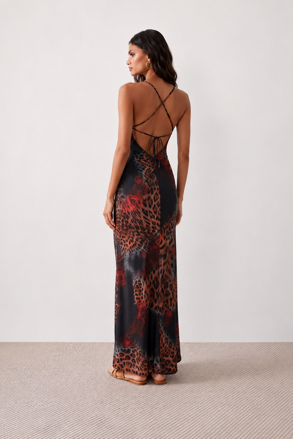 Woman wearing the Adelia Slip Spaghetti Strap Maxi Dress featuring a softly draped cowl neckline, delicate spaghetti straps, an open tie-back design and a flowing straight maxi skirt, styled for elegant evening occasions.