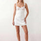 Women's Anahi lace slip mini dress featuring a sweetheart neckline, floral lace bustier with adjustable centre tie, low back, wide shoulder straps, and a satin-look A-line mini skirt, ideal for weddings, parties, and evening occasions.