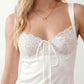 Women's Anahi lace slip mini dress featuring a sweetheart neckline, floral lace bustier with adjustable centre tie, low back, wide shoulder straps, and a satin-look A-line mini skirt, ideal for weddings, parties, and evening occasions.