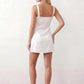 Women's Anahi lace slip mini dress featuring a sweetheart neckline, floral lace bustier with adjustable centre tie, low back, wide shoulder straps, and a satin-look A-line mini skirt, ideal for weddings, parties, and evening occasions.