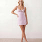 Women's Anahi lace slip mini dress featuring a sweetheart neckline, floral lace bustier with adjustable centre tie, low back, wide shoulder straps, and a satin-look A-line mini skirt, ideal for weddings, parties, and evening occasions.