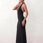 Woman wearing the Ariadna Mermaid Halter Maxi Dress featuring a deep plunge halter neckline, open back with adjustable tie fastening, gold-tone hardware at the ruched waist, subtle waist cut-out and a floor-length mermaid silhouette, ideal for weddings, black-tie events and formal evening occasions.