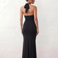 Woman wearing the Ariadna Mermaid Halter Maxi Dress featuring a deep plunge halter neckline, open back with adjustable tie fastening, gold-tone hardware at the ruched waist, subtle waist cut-out and a floor-length mermaid silhouette, ideal for weddings, black-tie events and formal evening occasions.