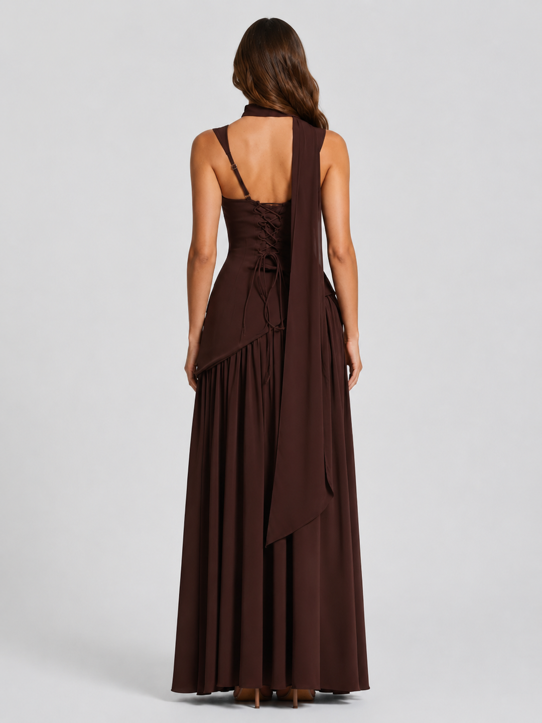 Woman wearing a satin-feel maxi dress with a sculpted bodice, asymmetric draped skirt, elegant side slit, and soft sheen for formal evening occasions.