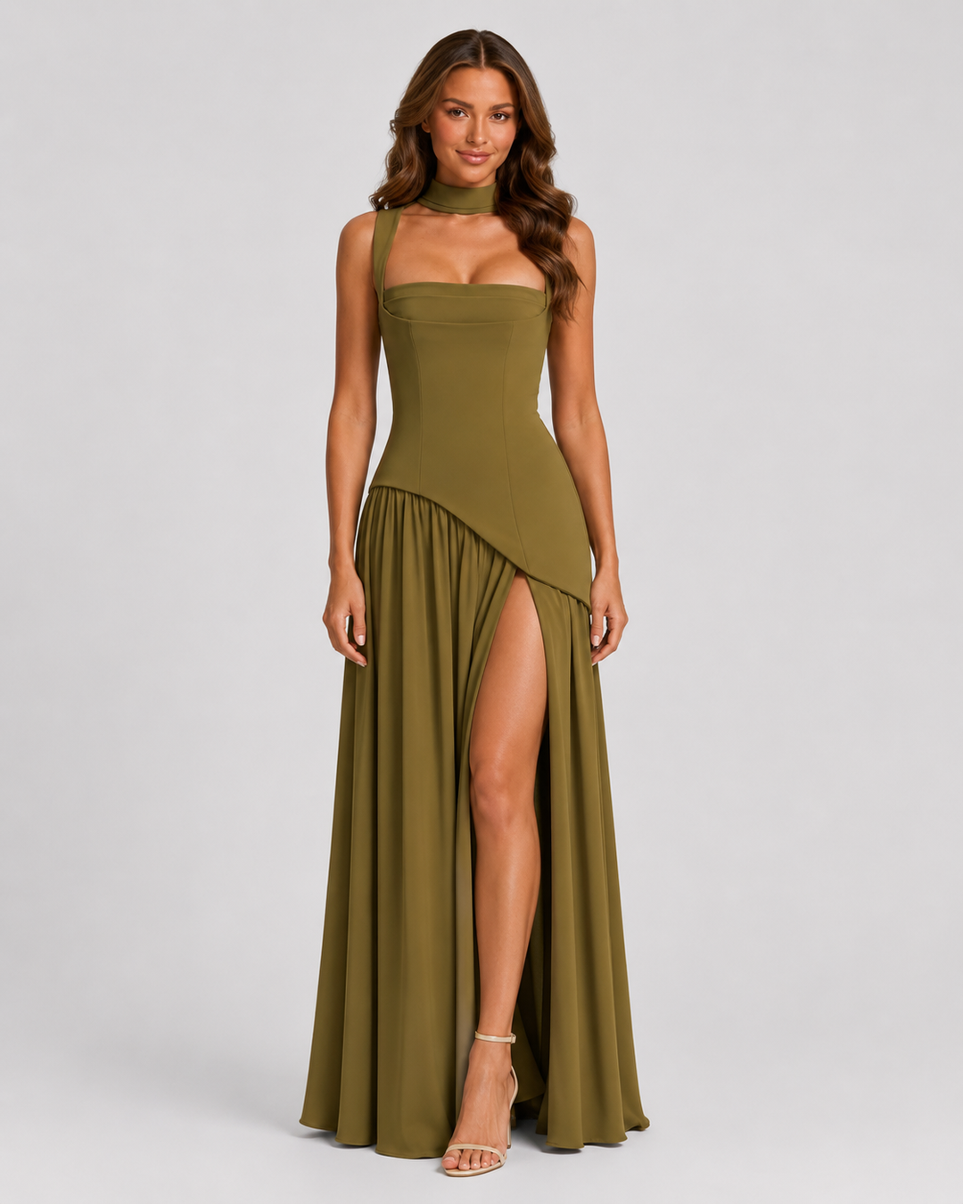 Woman wearing a satin-feel maxi dress with a sculpted bodice, asymmetric draped skirt, elegant side slit, and soft sheen for formal evening occasions.