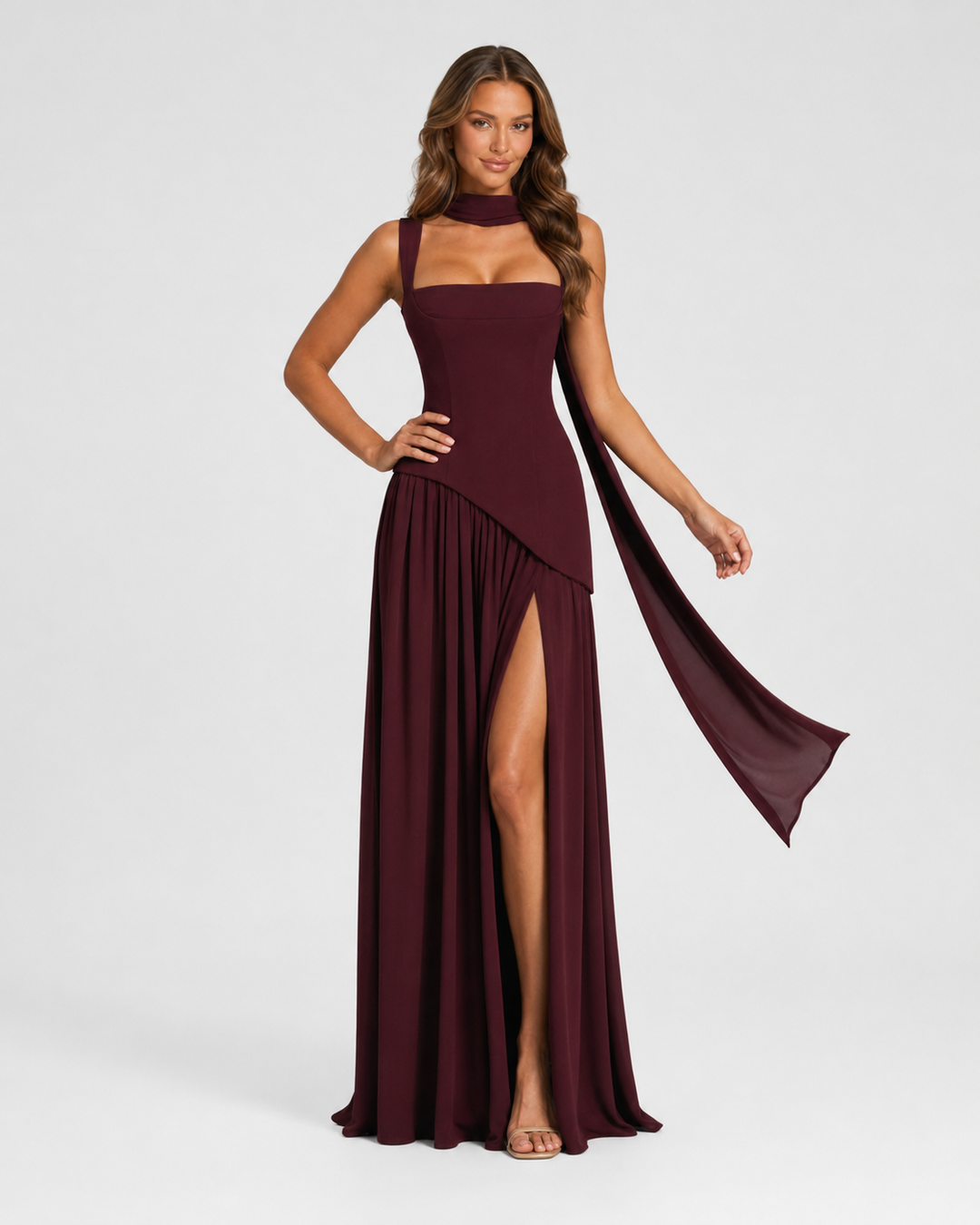 Woman wearing a satin-feel maxi dress with a sculpted bodice, asymmetric draped skirt, elegant side slit, and soft sheen for formal evening occasions.