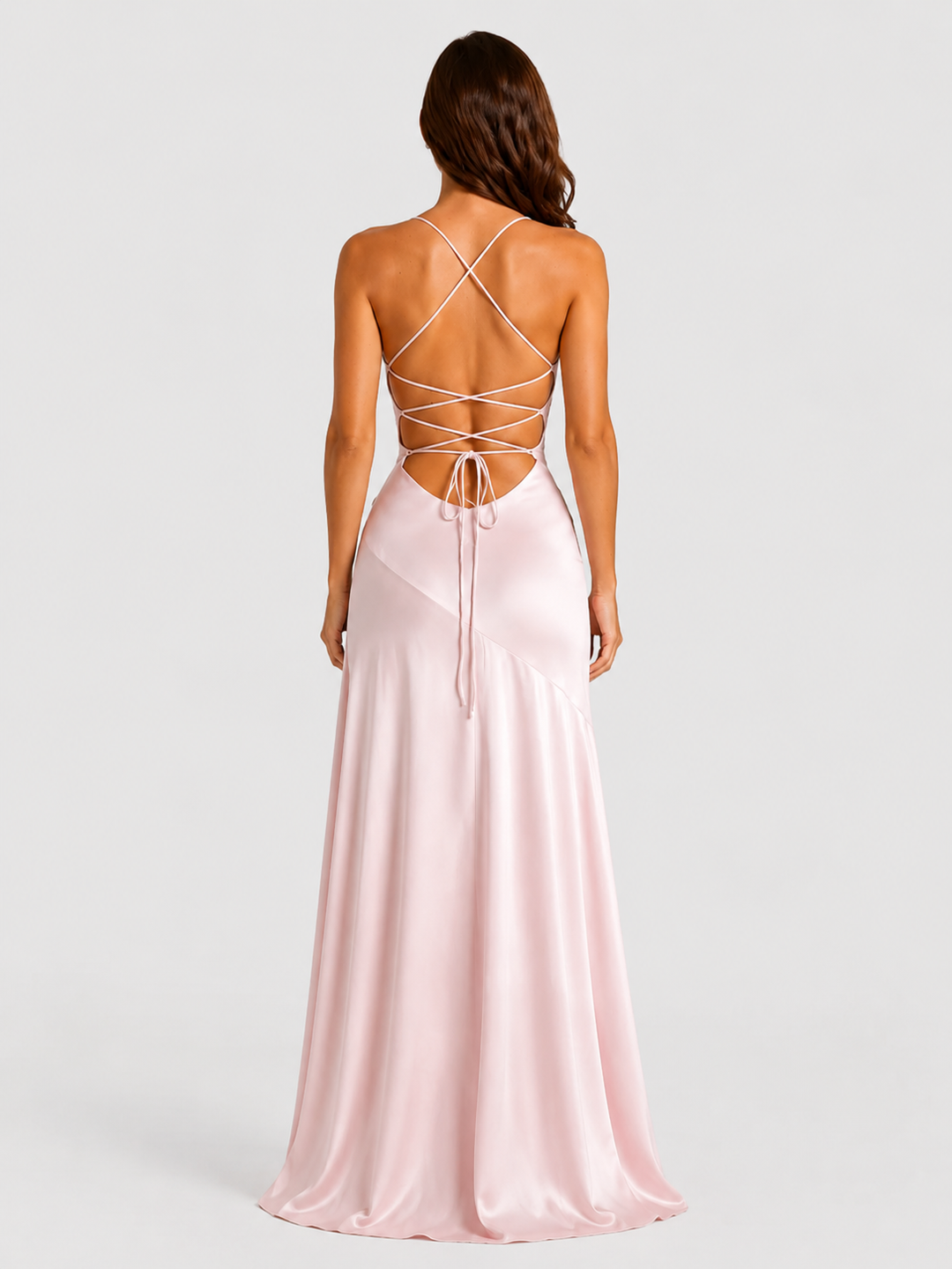 Woman wearing a strappy maxi dress with asymmetrical hem, flowing skirt and thigh-high split in a lightweight draped fabric for elegant evening occasions.