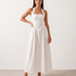 Aurora basque waist halter maxi dress with a halter neckline, open back, defined basque waist, and flowing A-line skirt in smooth fabric, ideal for weddings, formal events, and evening occasions.