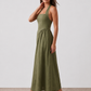 Aurora basque waist halter maxi dress with a halter neckline, open back, defined basque waist, and flowing A-line skirt in smooth fabric, ideal for weddings, formal events, and evening occasions.