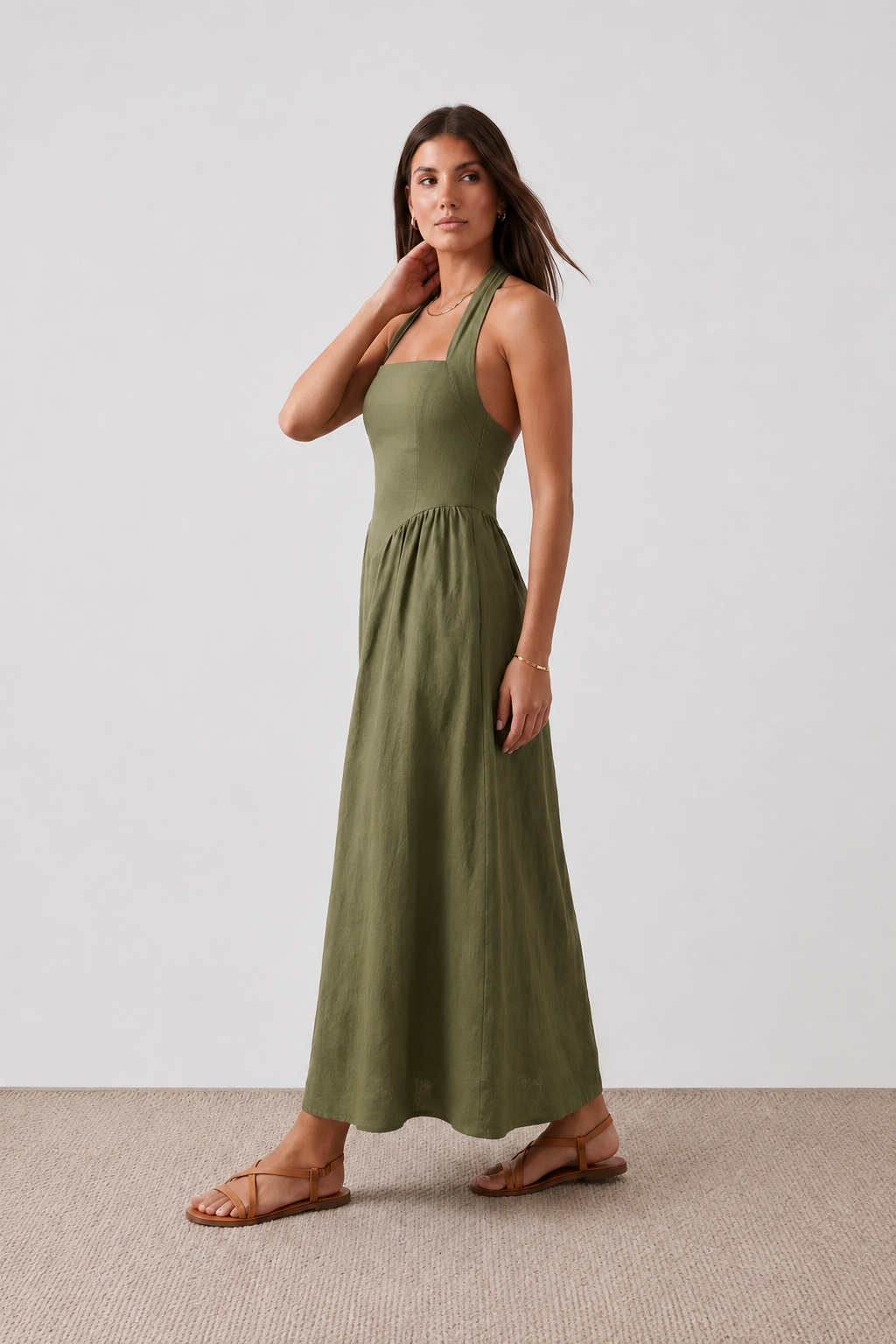 Aurora basque waist halter maxi dress with a halter neckline, open back, defined basque waist, and flowing A-line skirt in smooth fabric, ideal for weddings, formal events, and evening occasions.