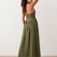 Aurora basque waist halter maxi dress with a halter neckline, open back, defined basque waist, and flowing A-line skirt in smooth fabric, ideal for weddings, formal events, and evening occasions.
