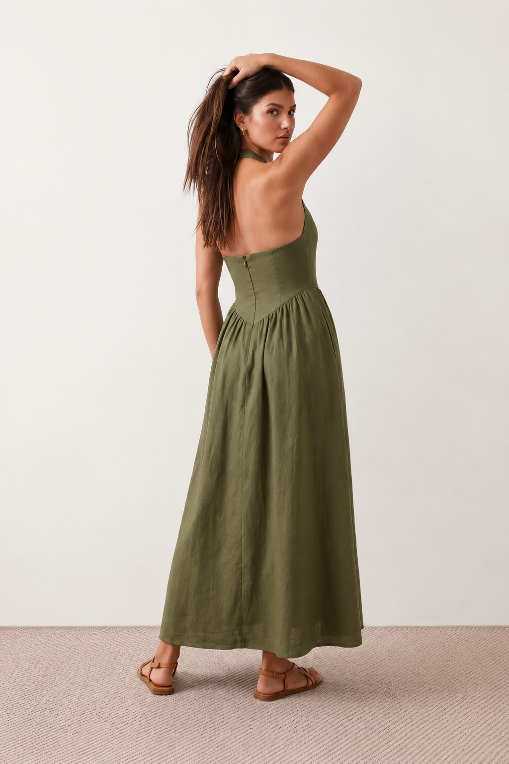Aurora basque waist halter maxi dress with a halter neckline, open back, defined basque waist, and flowing A-line skirt in smooth fabric, ideal for weddings, formal events, and evening occasions.