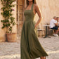 Aurora basque waist halter maxi dress with a halter neckline, open back, defined basque waist, and flowing A-line skirt in smooth fabric, ideal for weddings, formal events, and evening occasions.