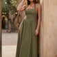 Aurora basque waist halter maxi dress with a halter neckline, open back, defined basque waist, and flowing A-line skirt in smooth fabric, ideal for weddings, formal events, and evening occasions.