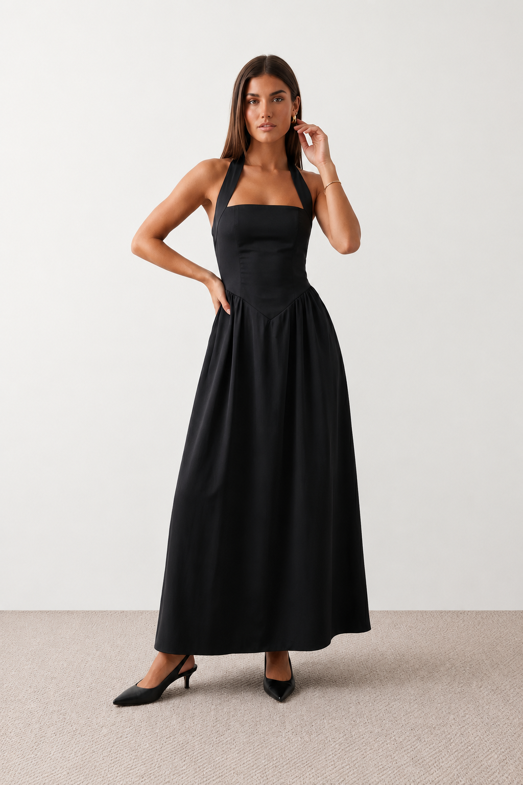 Aurora basque waist halter maxi dress with a halter neckline, open back, defined basque waist, and flowing A-line skirt in smooth fabric, ideal for weddings, formal events, and evening occasions.
