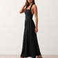 Aurora basque waist halter maxi dress with a halter neckline, open back, defined basque waist, and flowing A-line skirt in smooth fabric, ideal for weddings, formal events, and evening occasions.