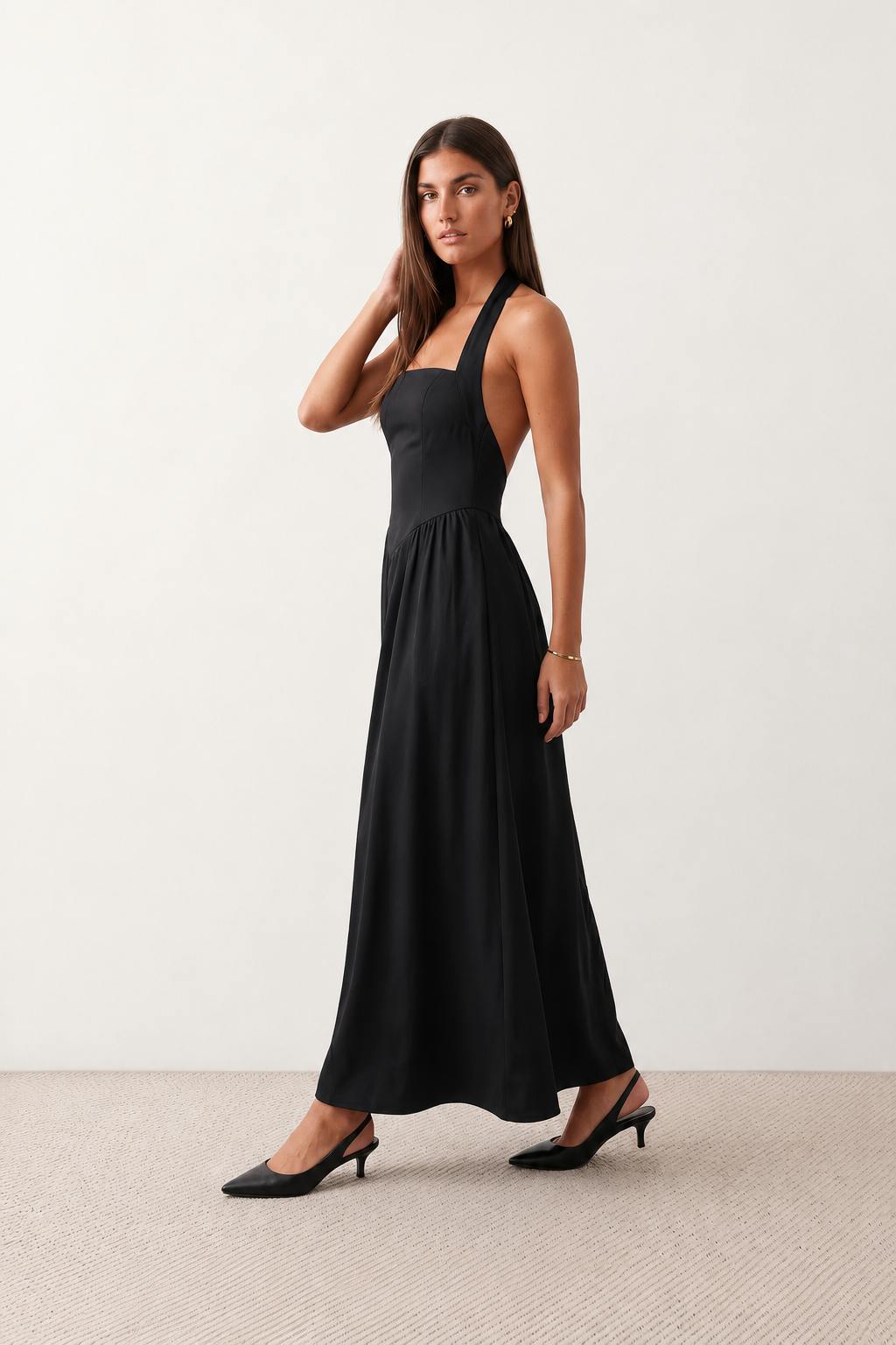 Aurora basque waist halter maxi dress with a halter neckline, open back, defined basque waist, and flowing A-line skirt in smooth fabric, ideal for weddings, formal events, and evening occasions.