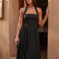 Aurora basque waist halter maxi dress with a halter neckline, open back, defined basque waist, and flowing A-line skirt in smooth fabric, ideal for weddings, formal events, and evening occasions.
