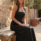 Aurora basque waist halter maxi dress with a halter neckline, open back, defined basque waist, and flowing A-line skirt in smooth fabric, ideal for weddings, formal events, and evening occasions.