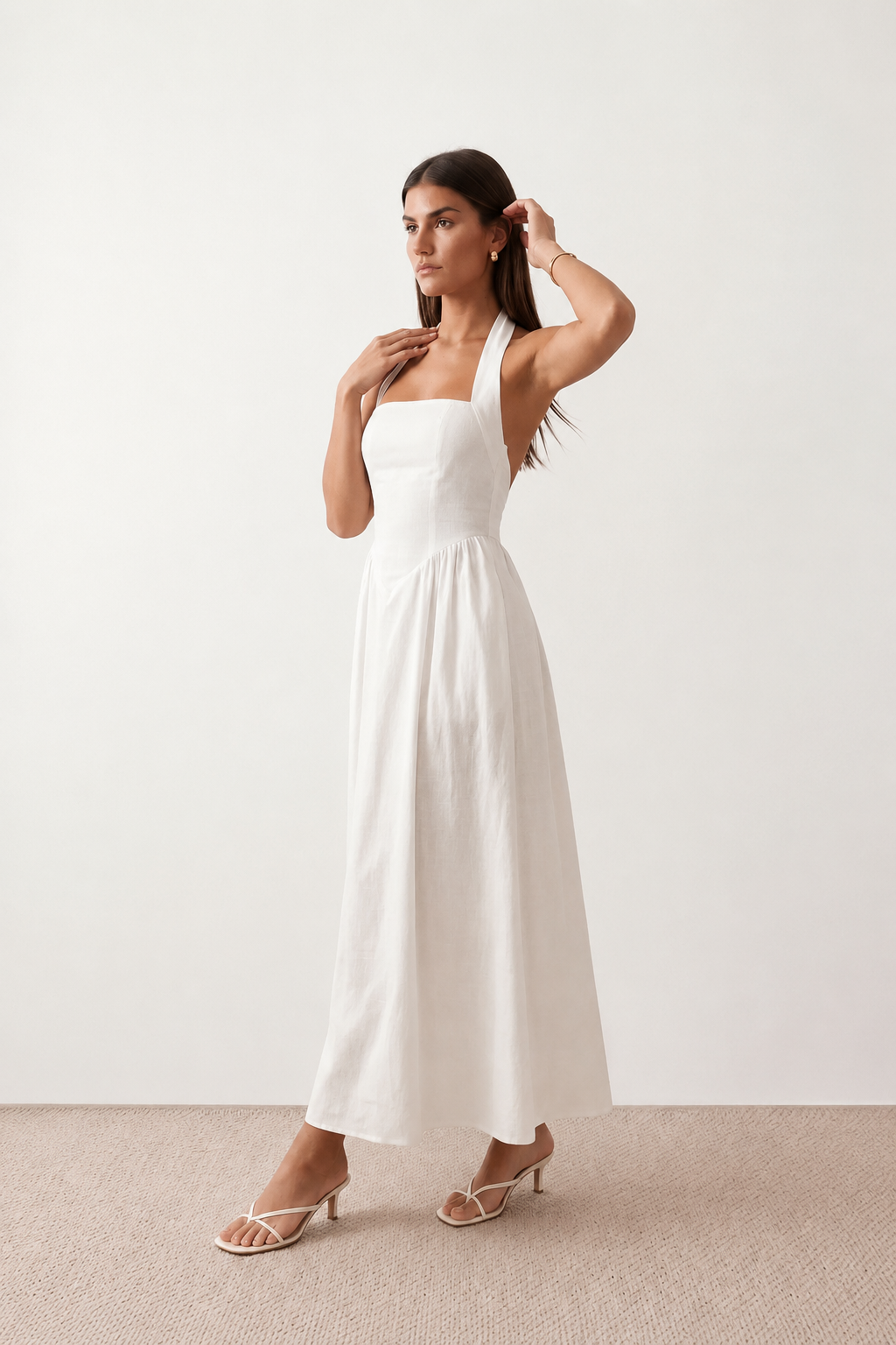 Aurora basque waist halter maxi dress with a halter neckline, open back, defined basque waist, and flowing A-line skirt in smooth fabric, ideal for weddings, formal events, and evening occasions.