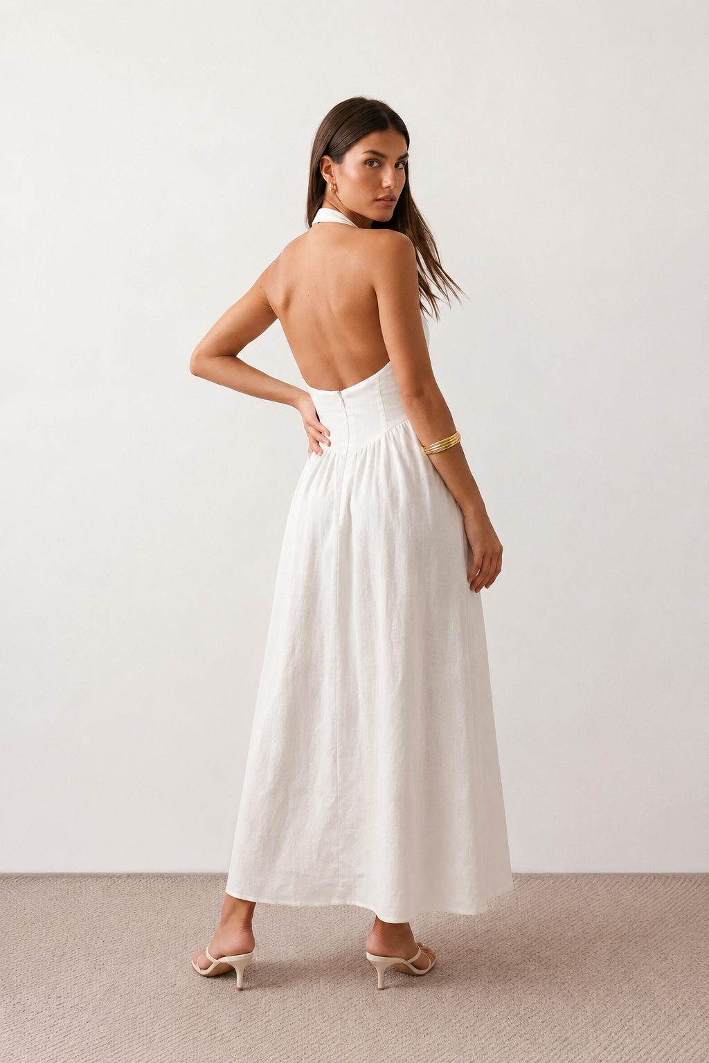 Aurora basque waist halter maxi dress with a halter neckline, open back, defined basque waist, and flowing A-line skirt in smooth fabric, ideal for weddings, formal events, and evening occasions.