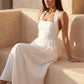 Aurora basque waist halter maxi dress with a halter neckline, open back, defined basque waist, and flowing A-line skirt in smooth fabric, ideal for weddings, formal events, and evening occasions.