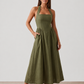 Aurora basque waist halter maxi dress with a halter neckline, open back, defined basque waist, and flowing A-line skirt in smooth fabric, ideal for weddings, formal events, and evening occasions.