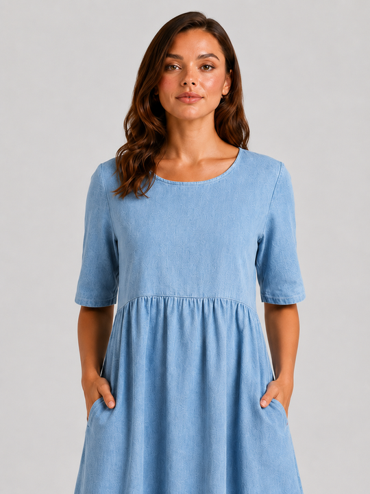 Woman wearing a relaxed-fit linen blend midi dress with a soft drape and breathable fabric, styled for effortless daytime elegance.