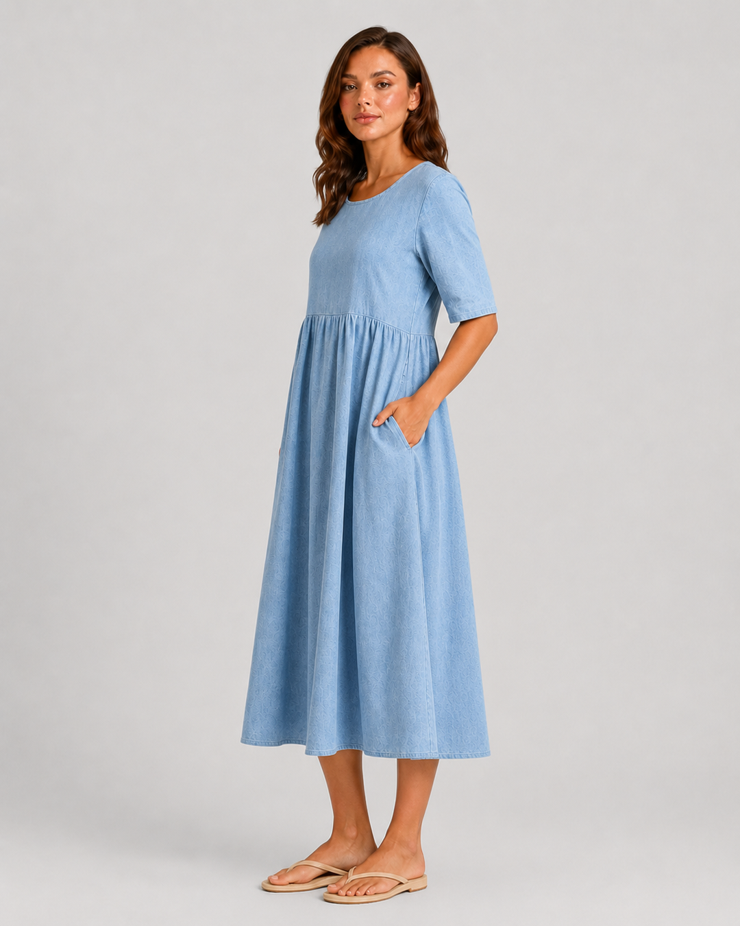 Woman wearing a relaxed-fit linen blend midi dress with a soft drape and breathable fabric, styled for effortless daytime elegance.