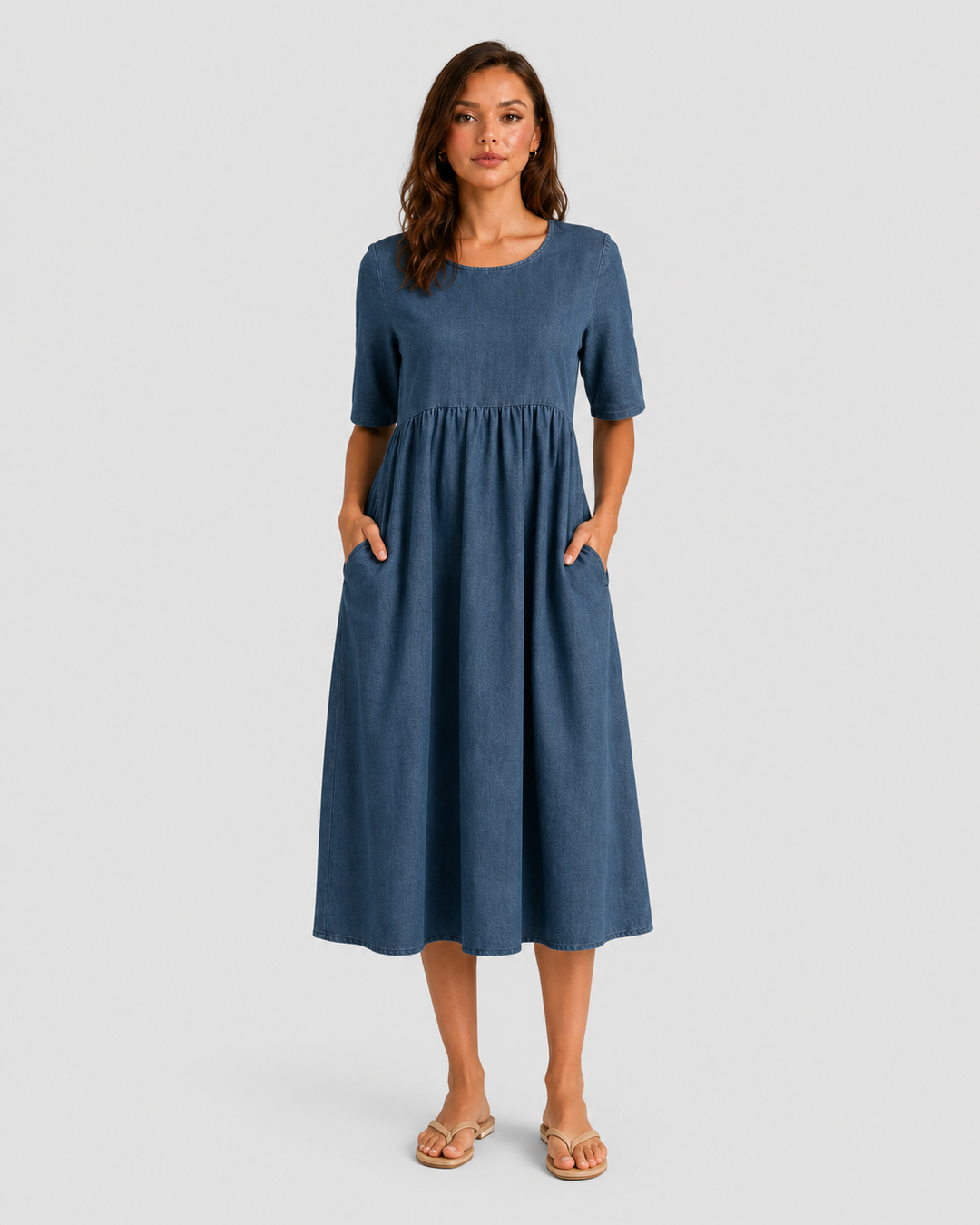 Woman wearing a relaxed-fit linen blend midi dress with a soft drape and breathable fabric, styled for effortless daytime elegance.