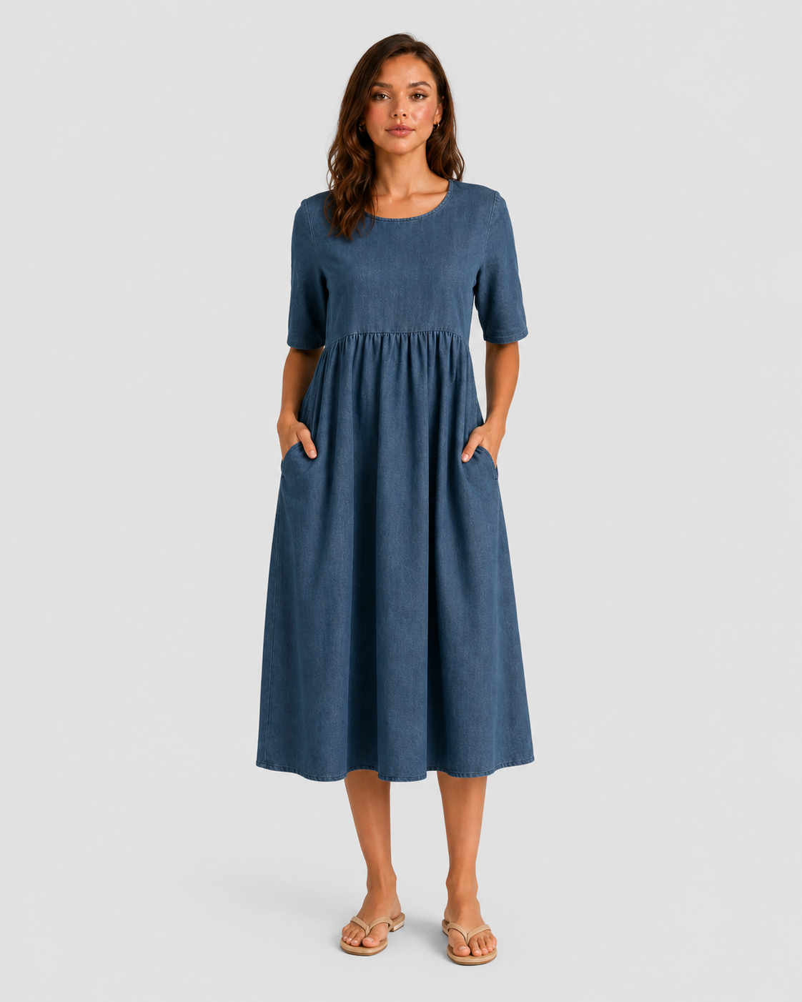 Woman wearing a relaxed-fit linen blend midi dress with a soft drape and breathable fabric, styled for effortless daytime elegance.