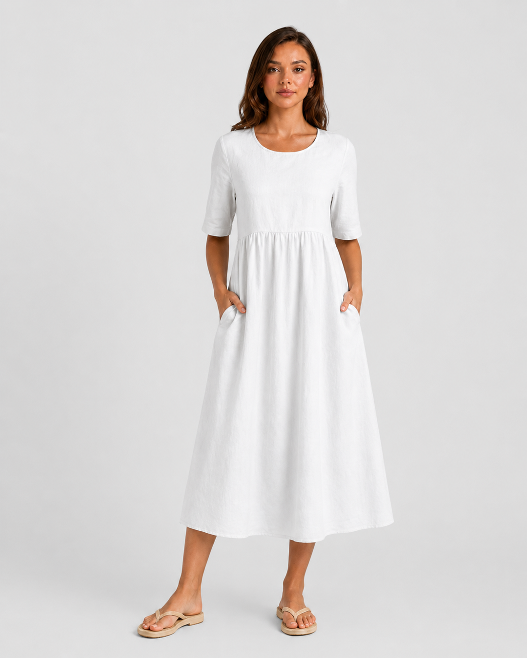 Woman wearing a relaxed-fit linen blend midi dress with a soft drape and breathable fabric, styled for effortless daytime elegance.