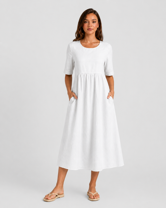 Woman wearing a relaxed-fit linen blend midi dress with a soft drape and breathable fabric, styled for effortless daytime elegance.