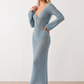 Woman wearing the Calixta Crochet Plunge Neck Maxi Dress in an elegant open-knit crochet design with a deep plunge V-neck, keyhole detail, long flared sleeves, low open back and fitted floor-length silhouette, ideal for beach holidays, festivals and summer occasion wear.