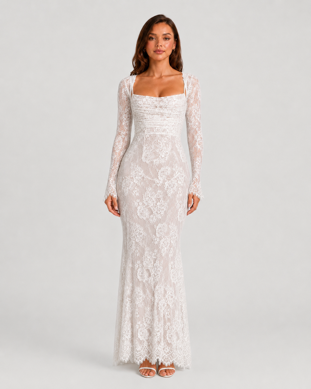 Woman wearing a lace corset maxi dress with a structured bodice, adjustable lace-up back, delicate lace detailing, and flowing floor-length silhouette.