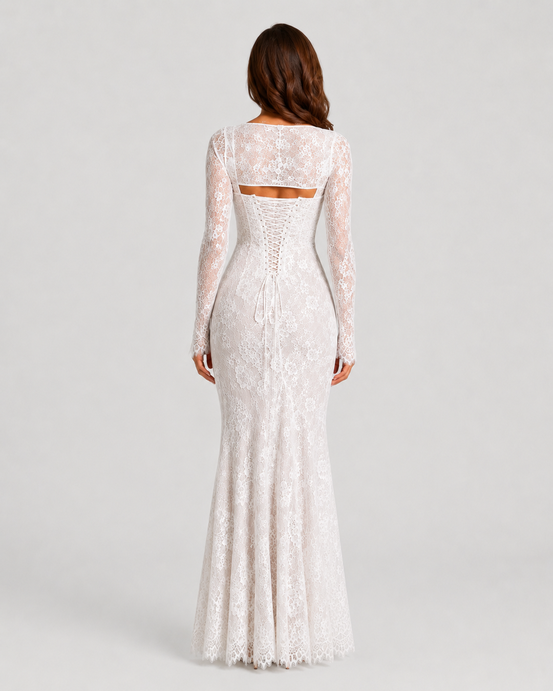Woman wearing a lace corset maxi dress with a structured bodice, adjustable lace-up back, delicate lace detailing, and flowing floor-length silhouette.