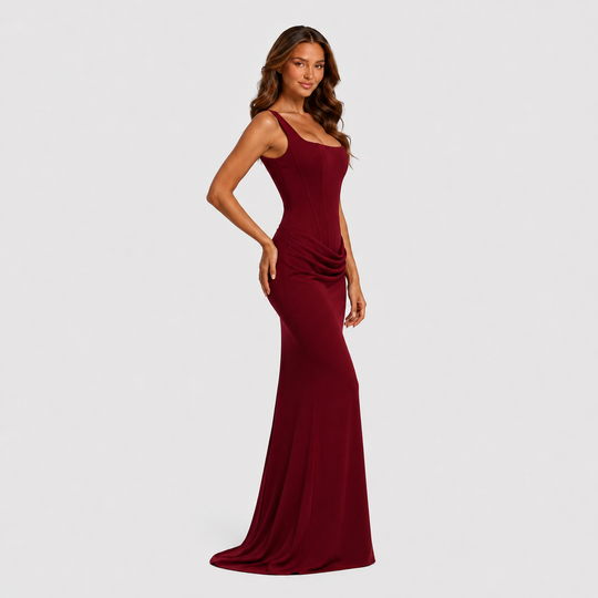 Women's elegant corset maxi dress featuring a structured bodice, dropped waist silhouette, and flowing pleated skirt for formal occasions.