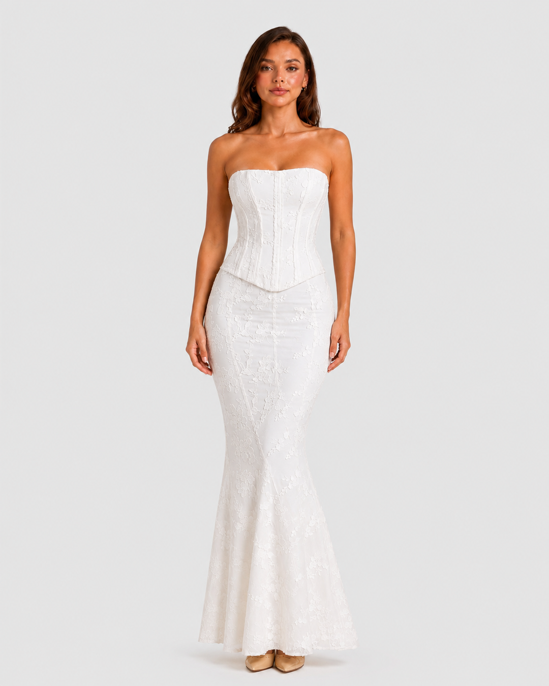 Women's floral embroidered corset gown with a fitted bodice, delicate embroidery, and softly flared hem in an elegant ivory-inspired design.